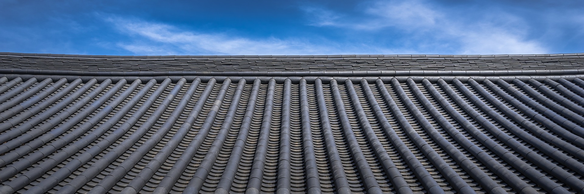 grey tile roof blue sky